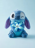 Blue Bloom plush holding its glowing flower