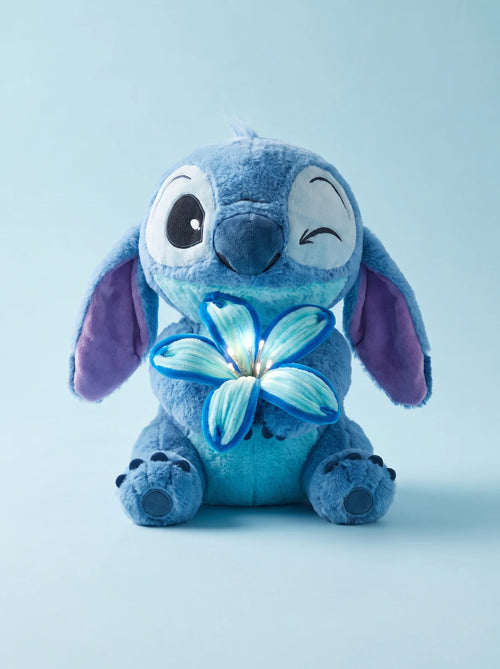 Blue Bloom plush holding its glowing flower