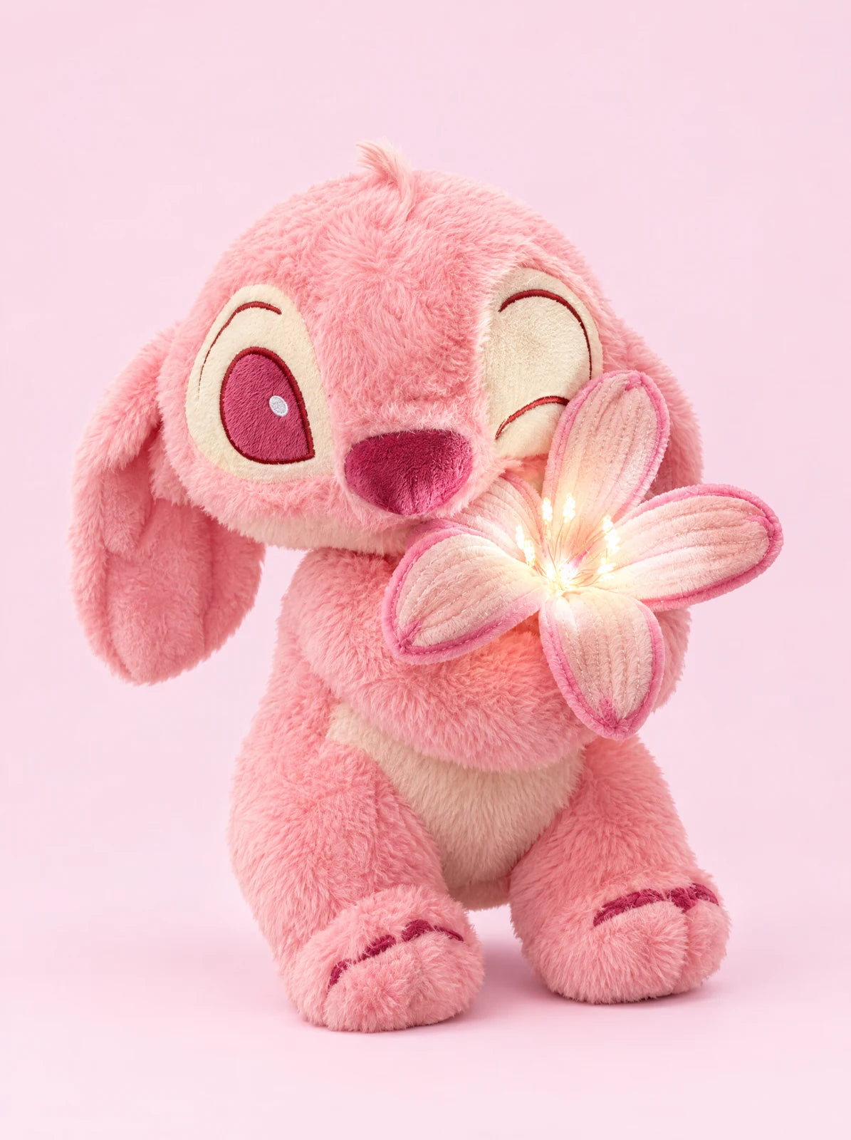 Pink Bloom plush holding its glowing flower